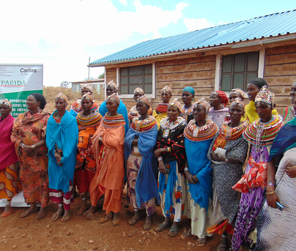 Gruppe von Frauen in traditioneller Kleidung vor einem Gebäude in Marsabit, Kenia, bei einer Schulung zu kaufmännischen Fertigkeiten